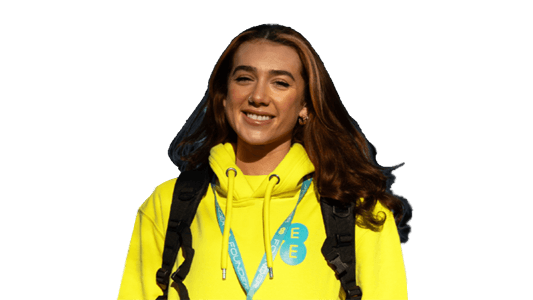 A woman wearing a yellow EE hoodie